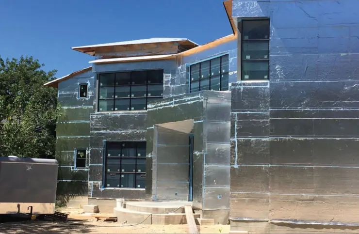 Residential house air barrier materials surrounding a home